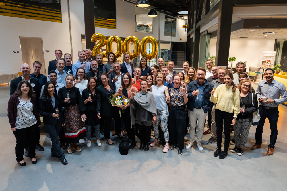 Group photo celebrating with bubble balloons and flowers